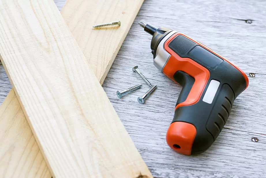 A mini electric screwdriver ready to be used on wood