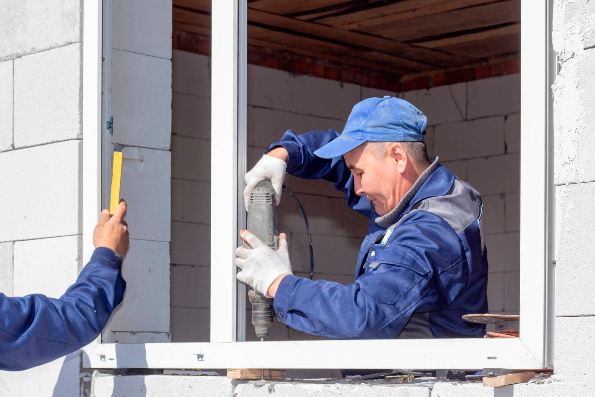 Specialists installing a window